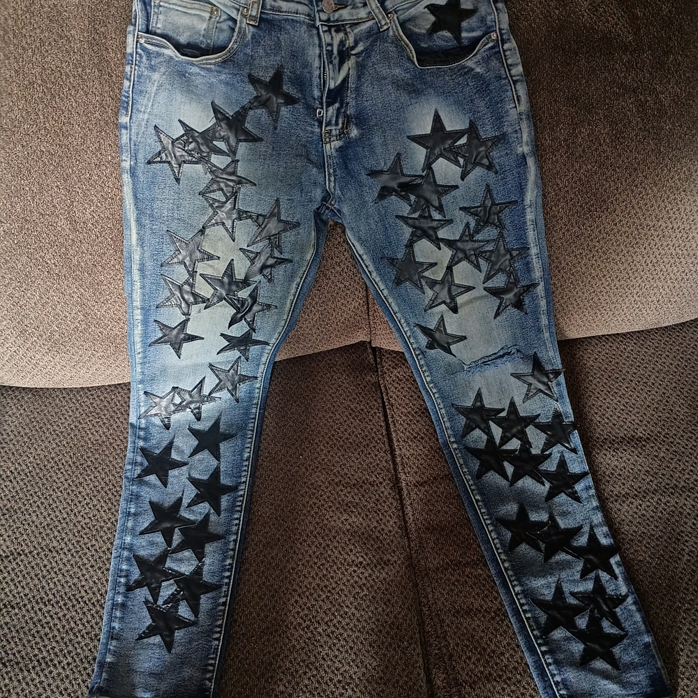 AMIRI Distressed Blue Jeans with Black Star Accents